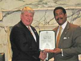 Former (MML) Maryland Municipal League President and Councilman Stewart Cumbo presenting Maryland House Speaker, Michael Busch, with a MML Certificate of Appreciation 